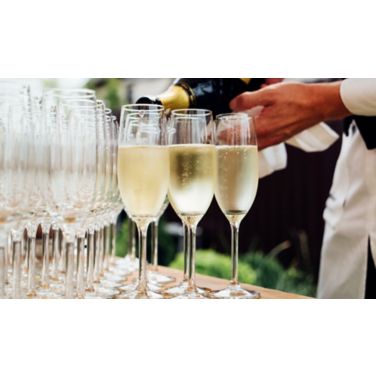 bartender filling glasses with champagne