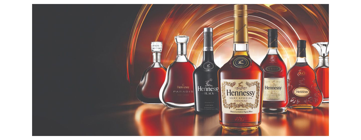 Bottles of Hennessy with a dark and light brown backdrop