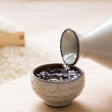 Sake being poured into a bowl