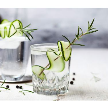 A glass of English gin with cucumber strip