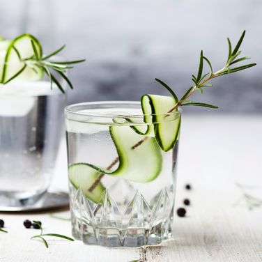 A glass of English gin with cucumber strip