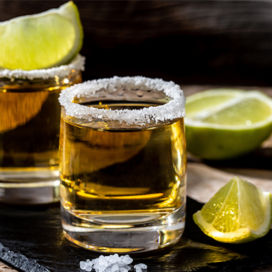 Tequila shot glasses with limes