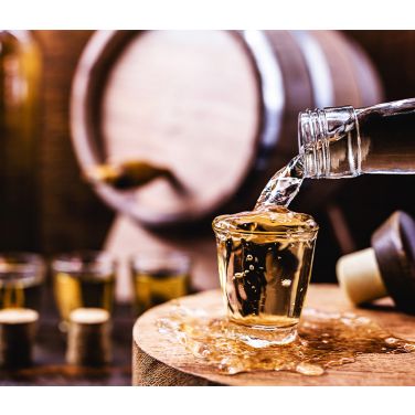 Rum being poured into a shot glass