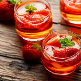 Shot glasses with vodka and strawberries