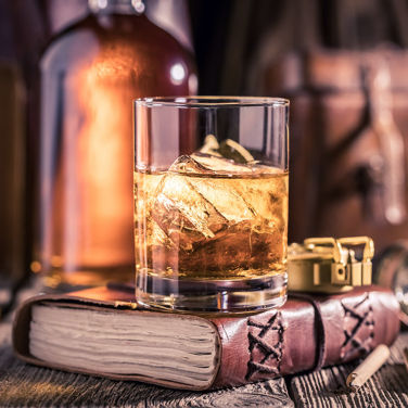Glass of whiskey on top of a book